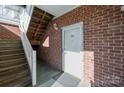 Brick building exterior, white door, wooden stairs at 9261 Meadow Vista Rd, Charlotte, NC 28213