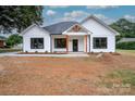 Modern farmhouse exterior with white siding and dark window frames at Lot 1 Hoke W St, Landis, NC 28088