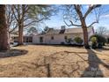 Spacious backyard with large trees and screened porch at 10512 Roseberry Ct, Charlotte, NC 28277