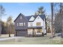 Stunning two-story home boasts a modern farmhouse design, featuring dark brick and white accents at 10605 S Hampton Dr, Charlotte, NC 28227