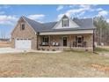 Charming brick home with a covered front porch and attached two car garage at 1076 Furnace Rd, Iron Station, NC 28080