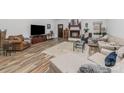 Spacious living room with a fireplace, hardwood floors, and neutral-colored furniture at 1076 Furnace Rd, Iron Station, NC 28080