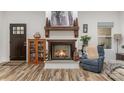 Cozy living room with a wood-burning fireplace, custom mantle, and decorative accents at 1076 Furnace Rd, Iron Station, NC 28080