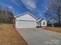 This home boasts an attached two-car garage and modern white siding at 1112 Wiscassett St, Albemarle, NC 28001