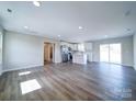 Open-concept living room showcases new flooring, recessed lighting, and access to the kitchen at 1112 Wiscassett St, Albemarle, NC 28001