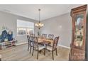 Formal dining room with wooden table and chandelier at 11906 Bending Branch Rd, Charlotte, NC 28227
