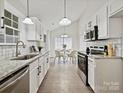Modern kitchen boasting granite countertops, white cabinets, and stainless steel appliances at 173 Brookshire Dr, Fort Mill, SC 29715
