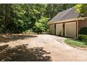 Two-car garage with brick exterior and large concrete driveway at 210 W Glenview Dr, Salisbury, NC 28147