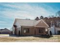 Picture of home showing backyard and driveway leading to a detached single car garage at 2220 Badin Rd, Albemarle, NC 28001