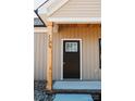 Close-up of the home's stylish front door and natural wood post at 2220 Badin Rd, Albemarle, NC 28001