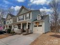 Charming two-story home featuring blue siding, brown shutters, and an attached garage at 3020 Graceland Cir # 11D, Pineville, NC 28134