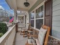 Relaxing front porch with rocking chairs and charming decor, perfect for enjoying the outdoors at 3020 Graceland Cir # 11D, Pineville, NC 28134