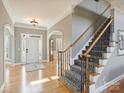 Inviting foyer with hardwood floors, staircase, arched entryways, and natural light at 3827 Bramwyck Dr, Charlotte, NC 28210