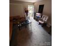 Living room features carpet flooring, a couch, and a rocking chair at 4818 Highlake Dr, Charlotte, NC 28215