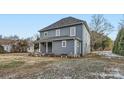 Rear view of a two-story gray house with a small deck at 502 E 2Nd St, Salisbury, NC 28146