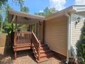Home features a wooden deck and stairs leading to backyard at 5024 Victoria Ave, Charlotte, NC 28269