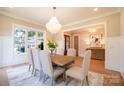 Bright dining room with chandelier and view into entryway at 720 Ideal Way, Charlotte, NC 28209