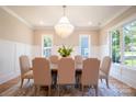 Formal dining room with a chandelier, large windows, and seating for six at 720 Ideal Way, Charlotte, NC 28209