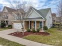 Two-story home with front porch and landscaping at 867 Pecan Tree Ln, Fort Mill, SC 29715