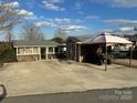 Property with a cottage, shed, and covered parking at 105 Richard Dr, New London, NC 28127