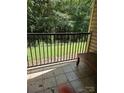 Balcony with black railing and outdoor seating, offering serene views of lush trees at 11041 Cedar View Rd, Charlotte, NC 28226
