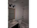 Bright bathroom featuring a vanity, toilet, and a shower-tub combo with white tile surround at 11041 Cedar View Rd, Charlotte, NC 28226