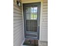 Front door with glass panes and matte black hardware, a welcome mat in front at 11041 Cedar View Rd, Charlotte, NC 28226
