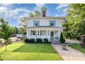 Charming two-story home with a welcoming front porch, lush green lawn, and mature landscaping at 132 N Confederate Ave, Rock Hill, SC 29730