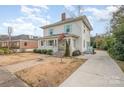 Charming two-story home with a welcoming front porch and cheerful blue shutters at 132 N Confederate Ave, Rock Hill, SC 29730