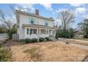 Charming two-story home with a welcoming front porch and cheerful blue shutters at 132 N Confederate Ave, Rock Hill, SC 29730