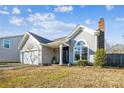 Gray house with a two-car garage and landscaped yard at 14333 Blue Granite Rd # 25, Pineville, NC 28134