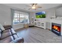 Spacious living room with fireplace, hardwood floors, and large window at 224 Butler Pl, Fort Mill, SC 29715