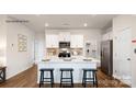 Modern kitchen with white cabinets, island, and stainless steel appliances at 301 Brinkley Dr, Kings Mountain, NC 28086