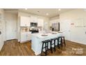 Modern kitchen featuring white cabinetry, stainless steel appliances, and an island with bar stool seating at 301 Brinkley Dr # Lot 103, Kings Mountain, NC 28086
