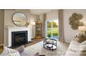 Cozy living room with fireplace, neutral decor, and sliding glass doors to the backyard at 301 Brinkley Dr, Kings Mountain, NC 28086