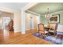 Formal dining room with hardwood floors, chandelier, and view into kitchen at 302 Mccrary Rd, Mooresville, NC 28117