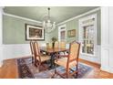 Formal dining room with wood floors, chandelier, and large windows at 302 Mccrary Rd, Mooresville, NC 28117
