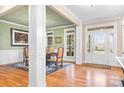 Bright entryway with hardwood floors, white columns, and view into dining area at 302 Mccrary Rd, Mooresville, NC 28117