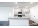 Modern kitchen with gray cabinets, granite counters, and island at 307 Brinkley Dr, Kings Mountain, NC 28086