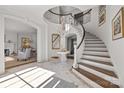 Grand entryway with a curved staircase and tile flooring at 413 Eastover Rd, Charlotte, NC 28207