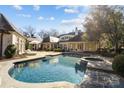 Inviting kidney shaped pool with a spa and spacious patio at 413 Eastover Rd, Charlotte, NC 28207