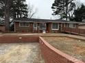 Brick ranch home with a landscaped yard and walkway at 4718 Americana Ave, Charlotte, NC 28215