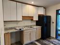 Kitchen with wood cabinets, granite counters, and black appliances at 4718 Americana Ave, Charlotte, NC 28215