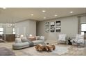 Spacious living room with a stylish sectional sofa and large artwork at 714 Falling Oak Aly, Huntersville, NC 28078