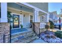 Inviting front porch with stone pillars and a blue ceiling at 724 Mercer Pl, Huntersville, NC 28078