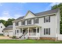 Traditional home featuring a welcoming porch, well-maintained landscaping, and an attached three-car garage at 7545 Haley Ln, Indian Land, SC 29707