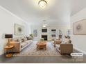 Spacious living room with fireplace and virtually staged furniture at 9153 Leah Meadow Ln, Charlotte, NC 28227