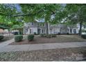 Street view of a row of gray townhomes with landscaping at 1208 Piedmont St, Charlotte, NC 28204