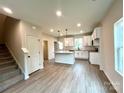 Modern kitchen with white cabinets, granite countertops, and an island at 129 Sharon Rd, York, SC 29745