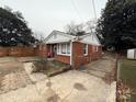 Brick ranch home with a spacious yard and a modern fence at 1401 Lasalle St, Charlotte, NC 28216